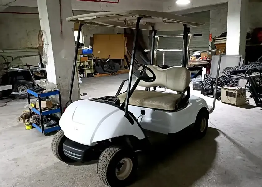 Yamaha Drive golf cart in a repair workshop