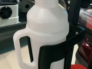 Sand bottle in a holder on a golf cart